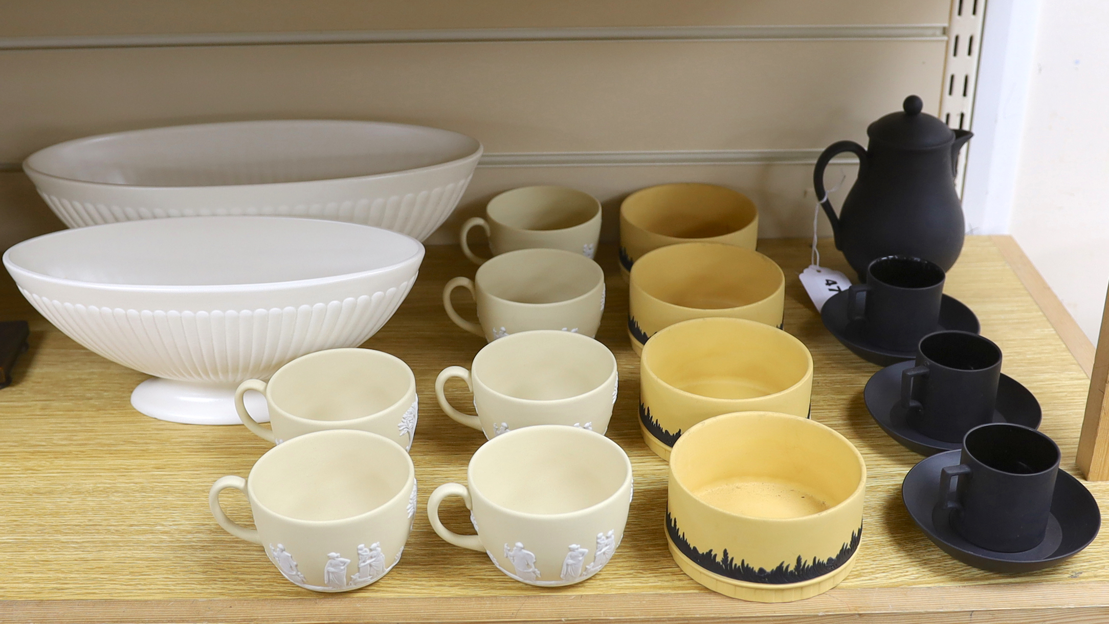 A Wedgwood black basalt coffee pot with three coffee cans and saucers, six biscuit jasper ware cups, four pots and two Etruria vases, largest vase 32cm wide, 32cm wide